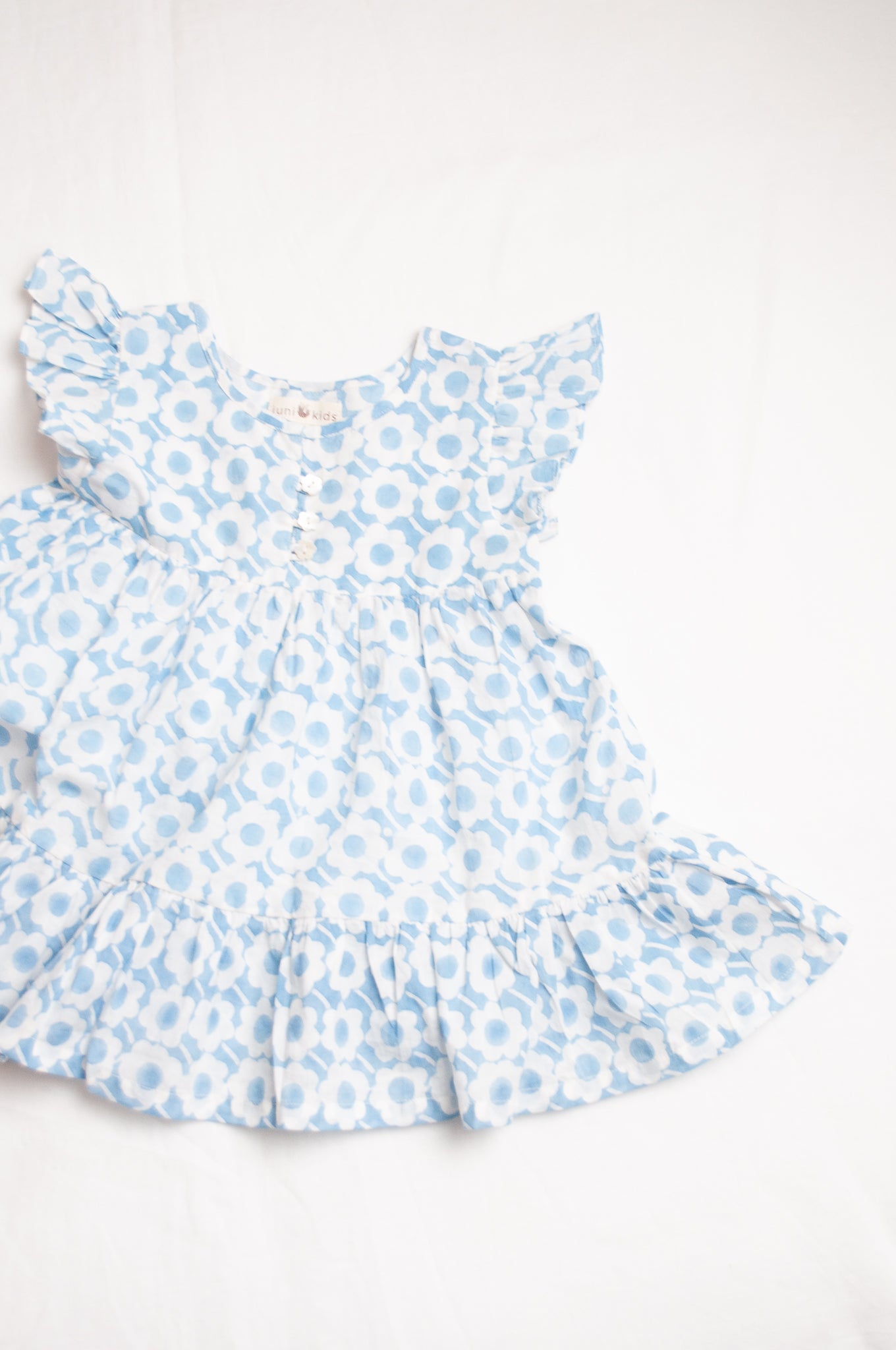 Juni Kids pure cotton blockprint baby dress in light blue and white floral pattern.