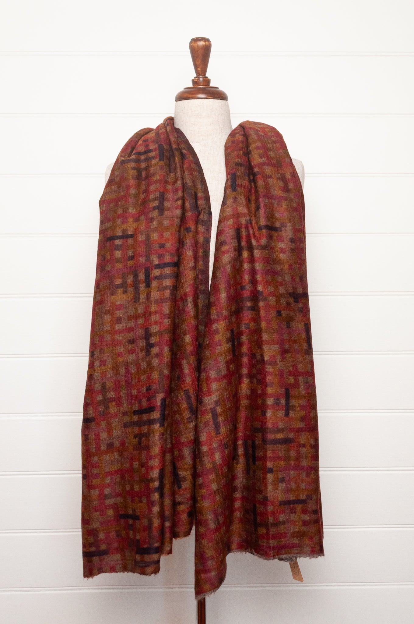 Neeru Kumar superfine wool scarf digital print check pattern in rust red, brown, and dark charcoal gray.