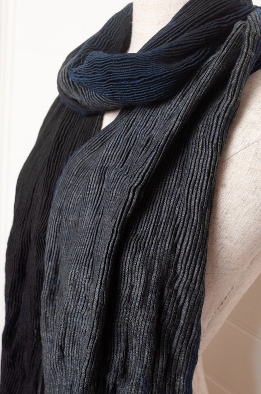 Neeru Kumar pure wool shibori dyed crinkle pleat finish scarf in indigo blue, and charcoal grey.