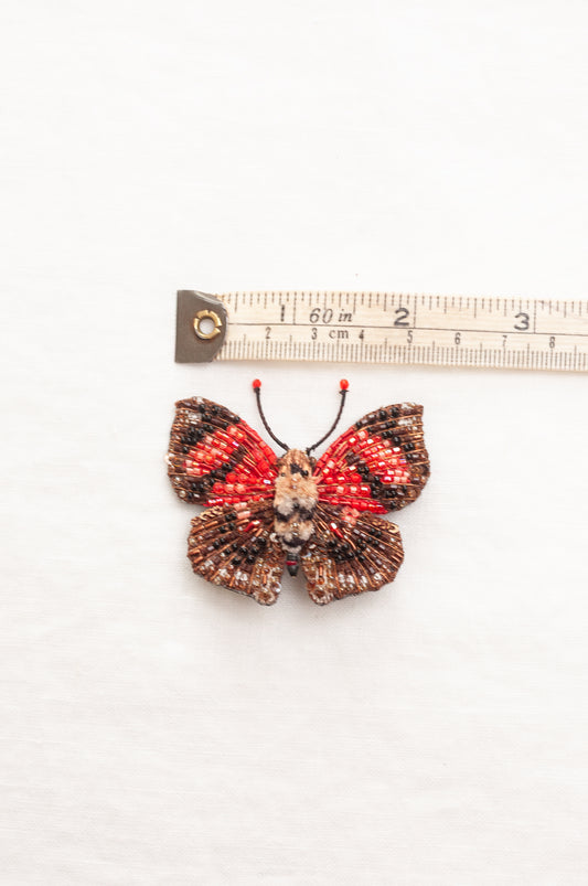 Trovelore hand beaded Scarlet leafwing butterfly, handcrafted butterfly-shaped brooch red and black patterned wings with a textured brown body.