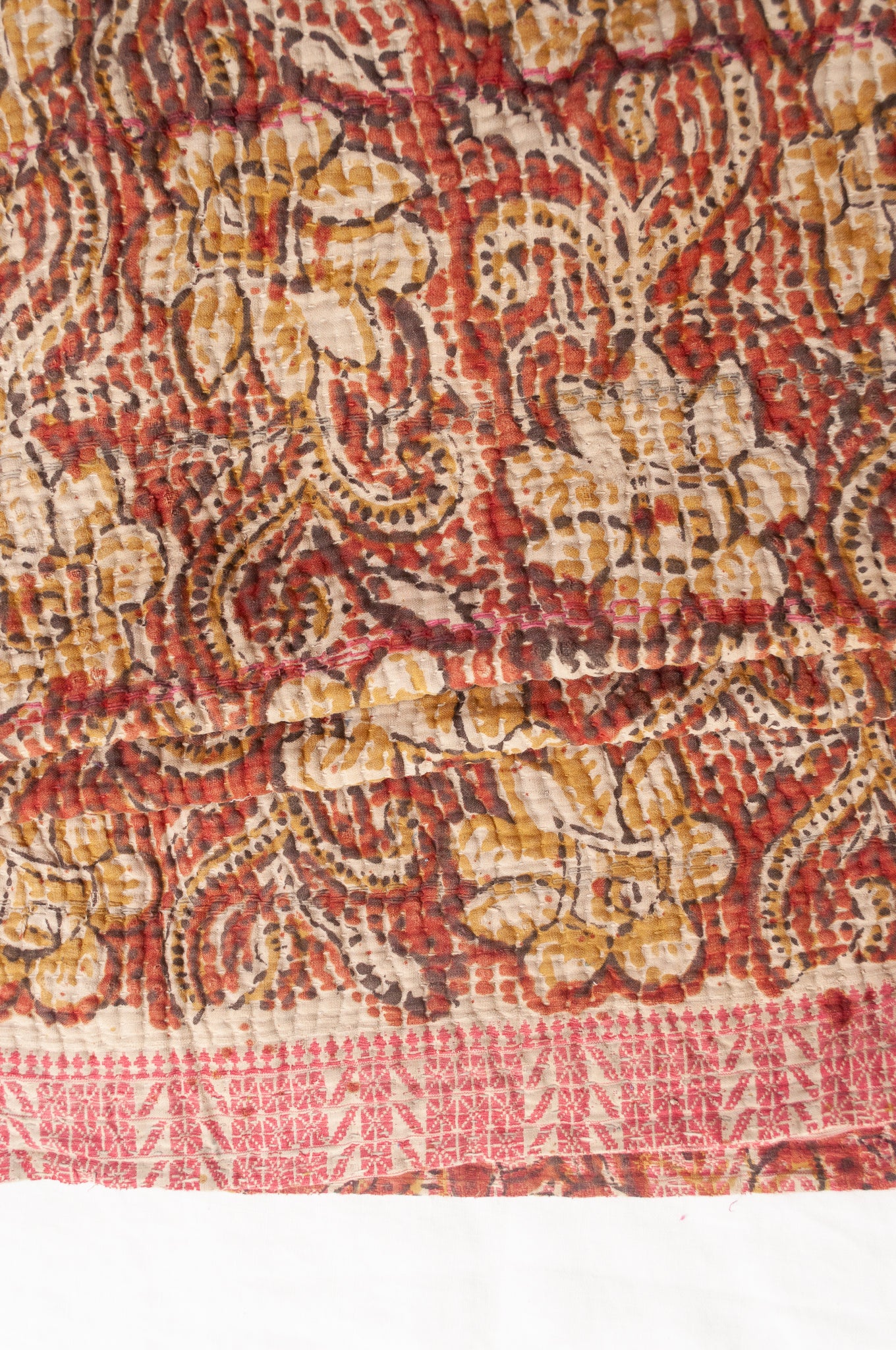 Vintage bagru blockprinted kantha quilt, floral design in rust red and mustard yellow, with red traditional decorative embroidery