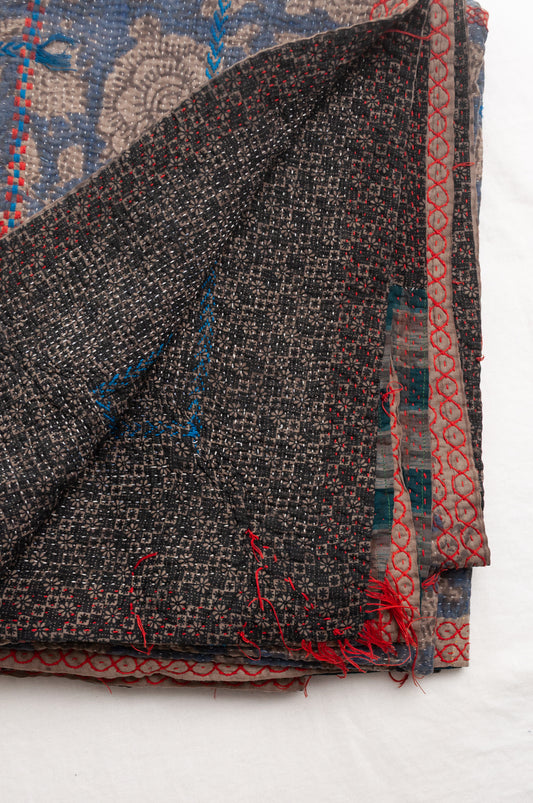 Vintage kantha quilt Bagru blockprinted in indigo floral design with red and cobalt blue embroidery.