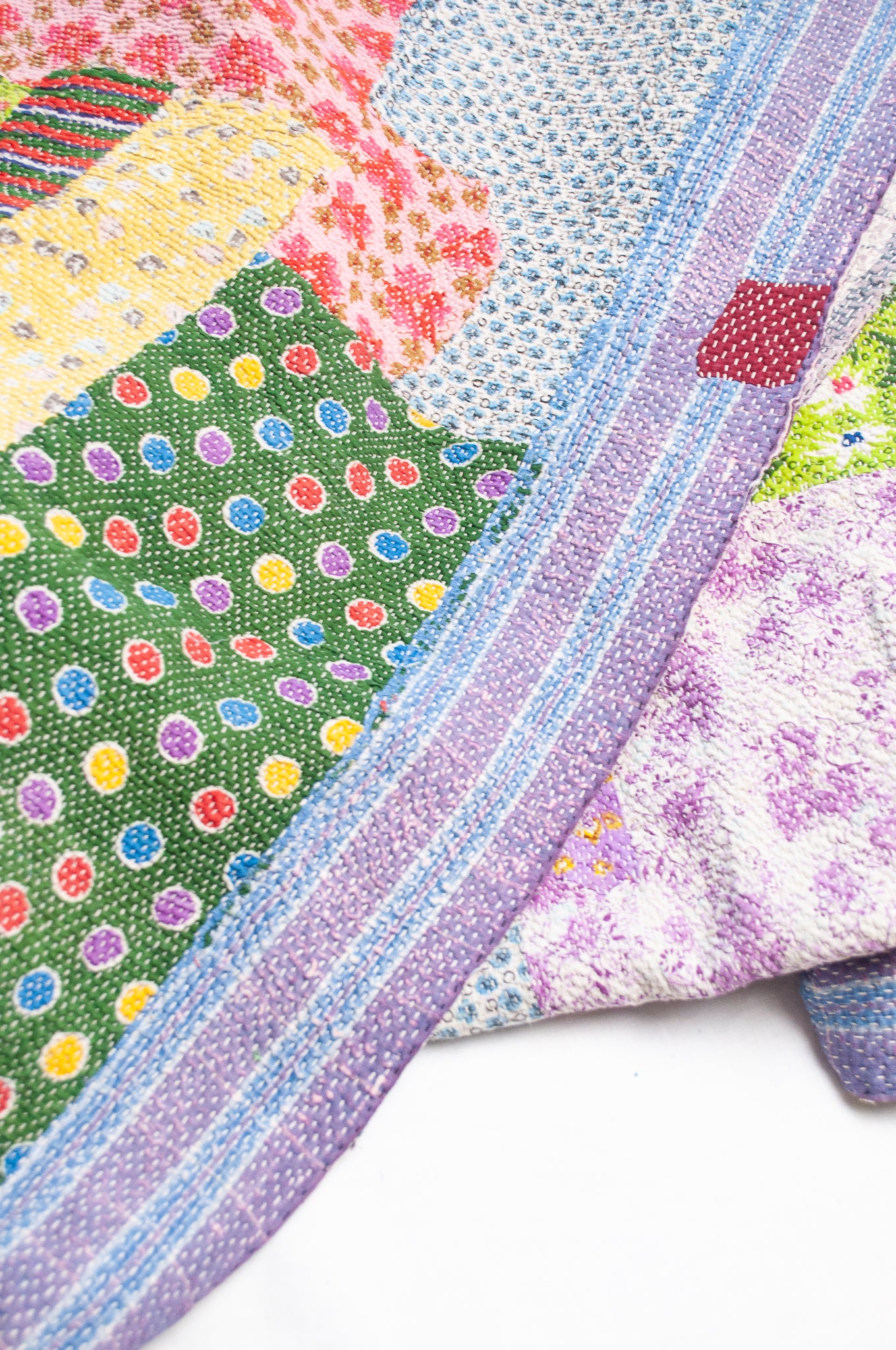 Colourful patchwork kantha quilt featuring cheerful retro prints.