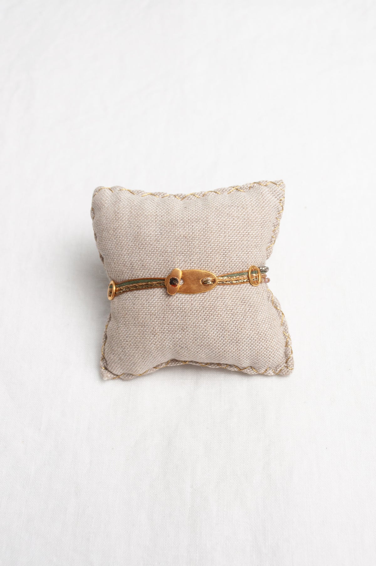 Mary Gaitani stranded wax cord bracelet with semi-precious stones and gold teardrop charms.
