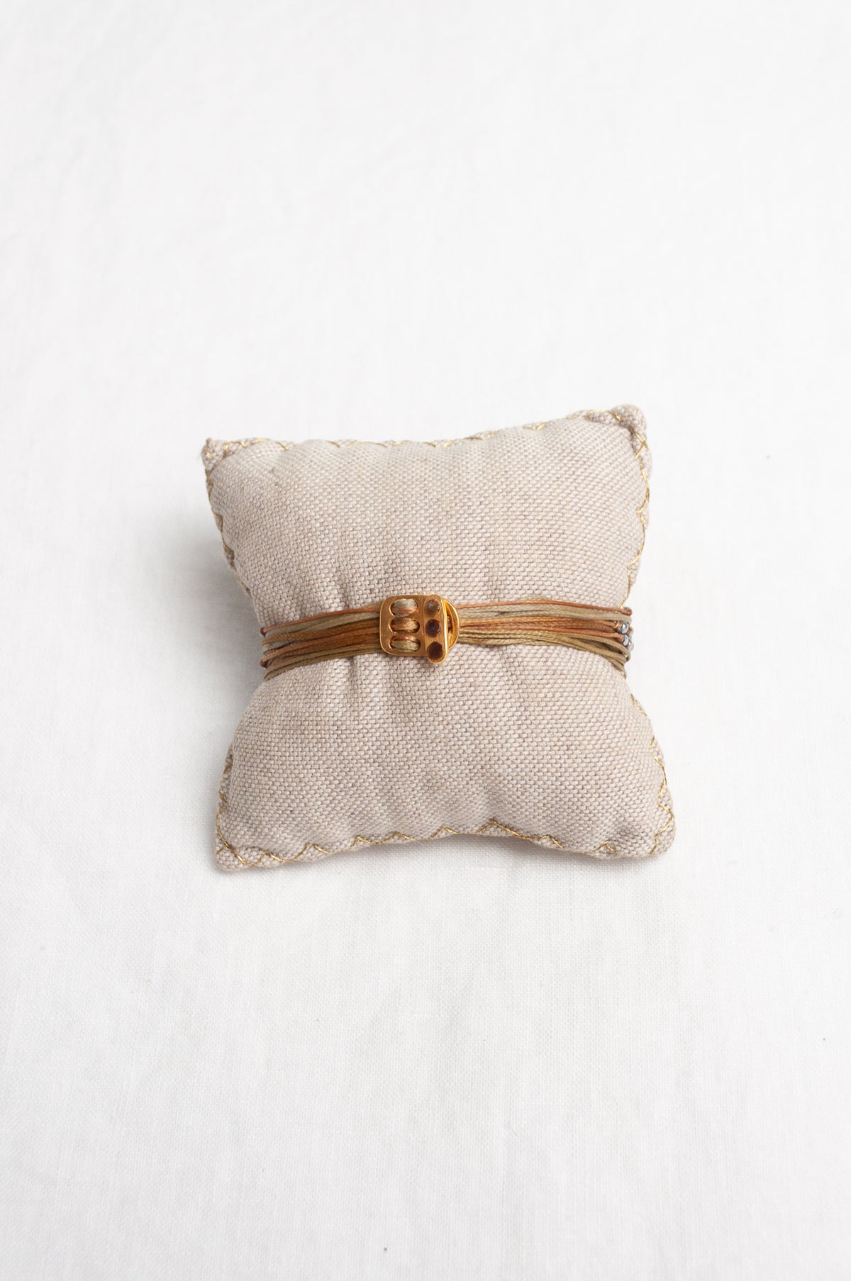 Mary Gaitani stranded wax cord bracelet with semi-precious stones and gold and silver charms.