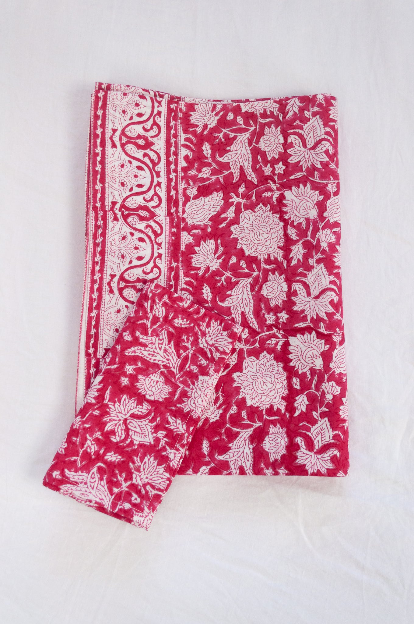Blockprinted cotton table cloth in raspberry red and white floral design, made by hand