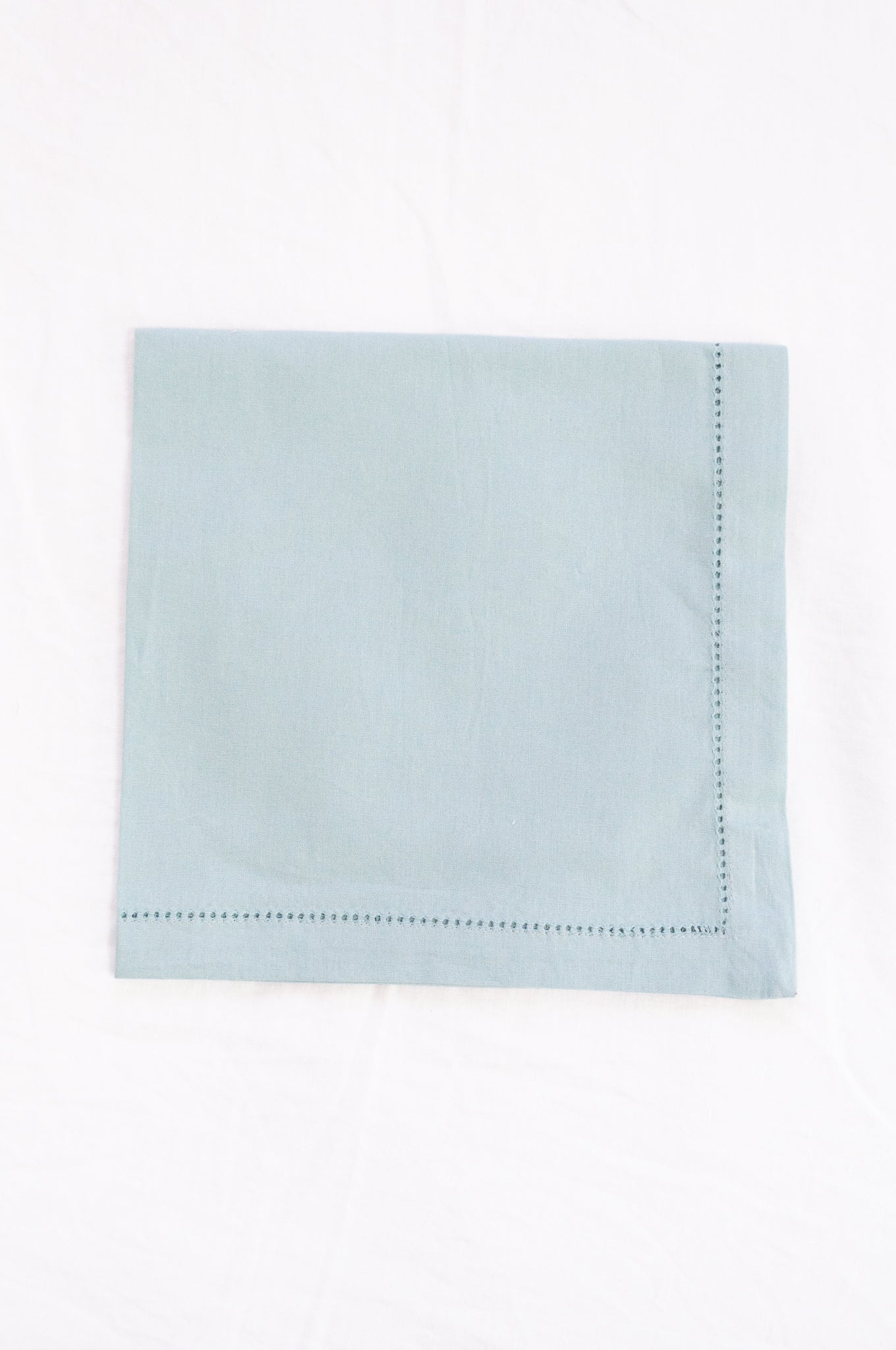 Plain cotton napkins with faggot hem detail in celadon.