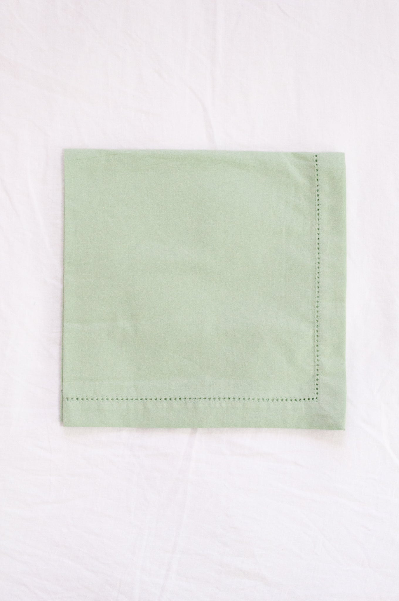 Plain cotton napkins with faggot hem detail in sage.