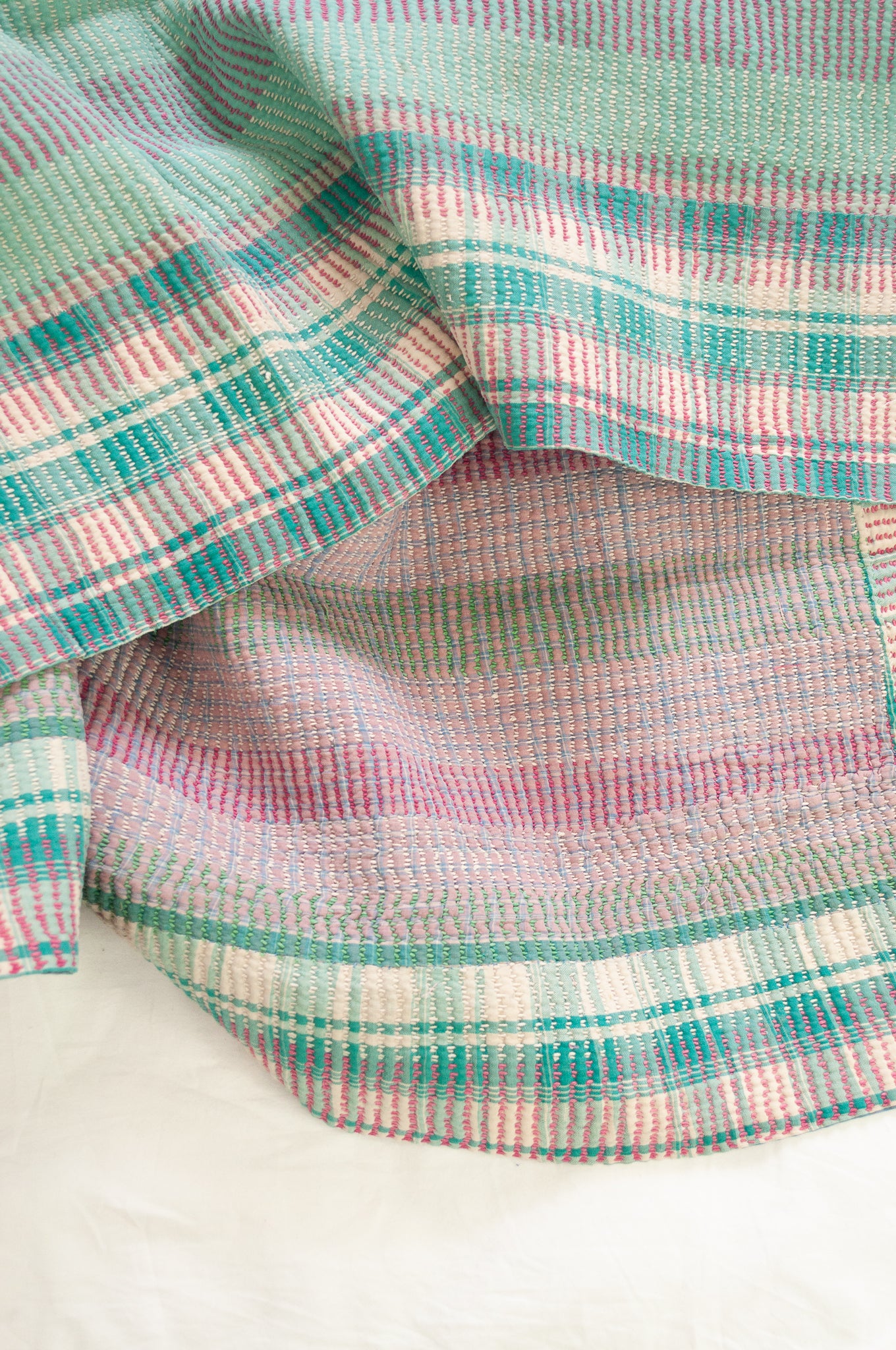 Vintage kantha quilt in pastel stripes and checks, mint, rose pink, lavender and white.