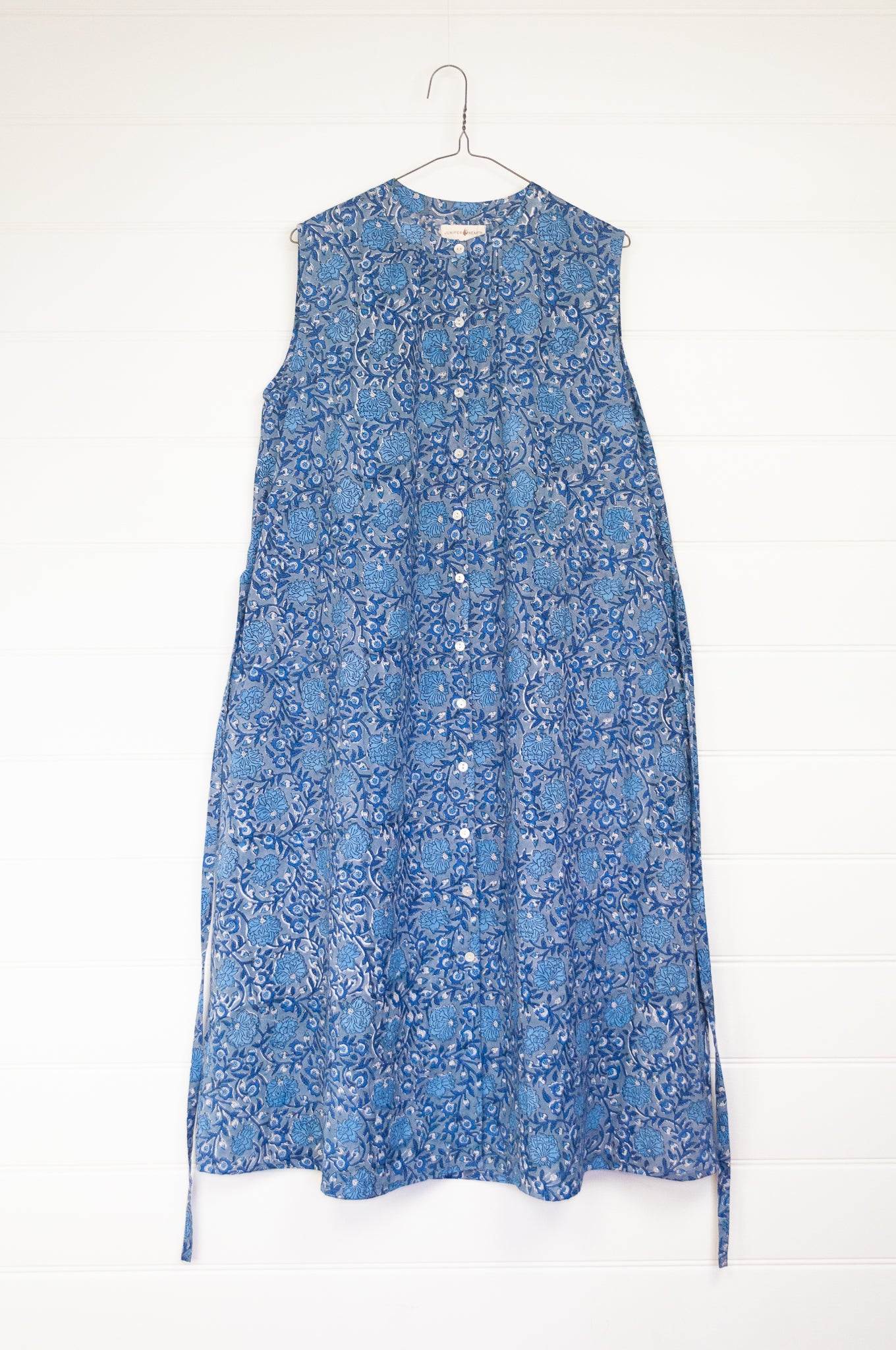 Juniper hearth Zoe dress button up sleeveless with waist ties, made from cotton blue grey blockprint floral.