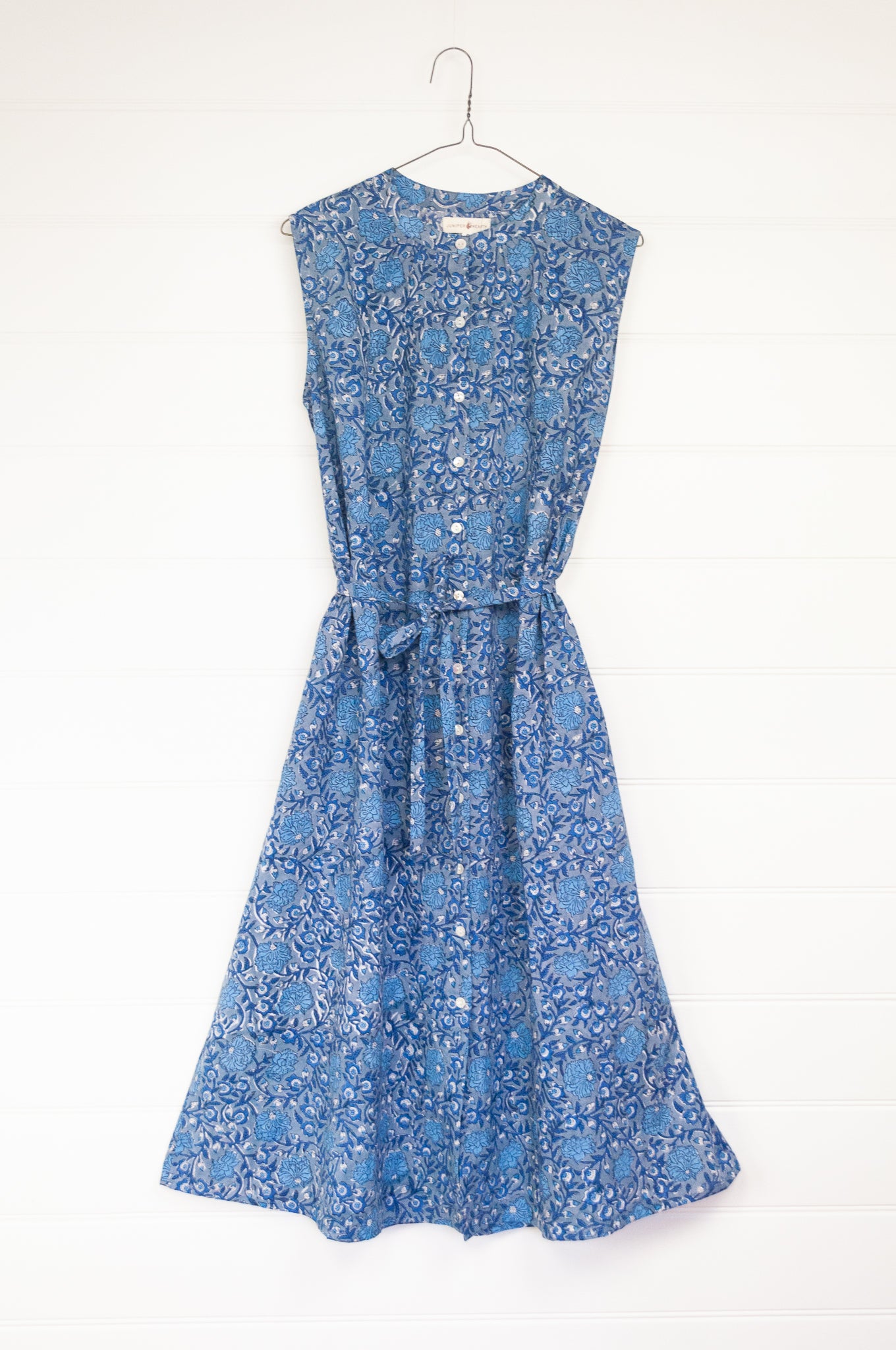 Juniper hearth Zoe dress button up sleeveless with waist ties, made from cotton blue grey blockprint floral.