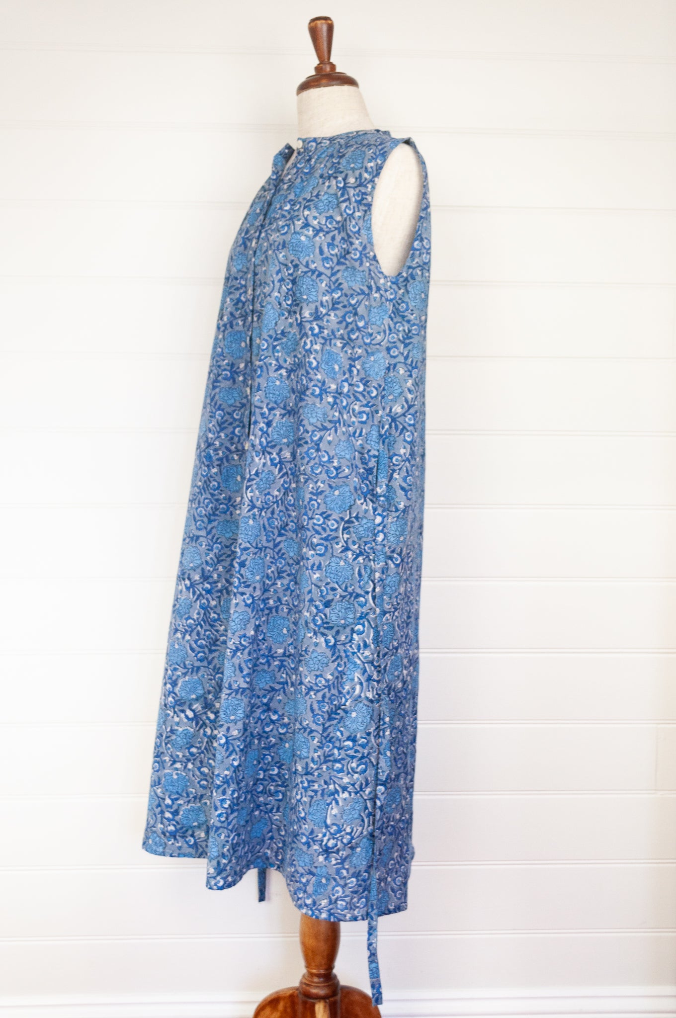 Juniper hearth Zoe dress button up sleeveless with waist ties, made from cotton blue grey blockprint floral.