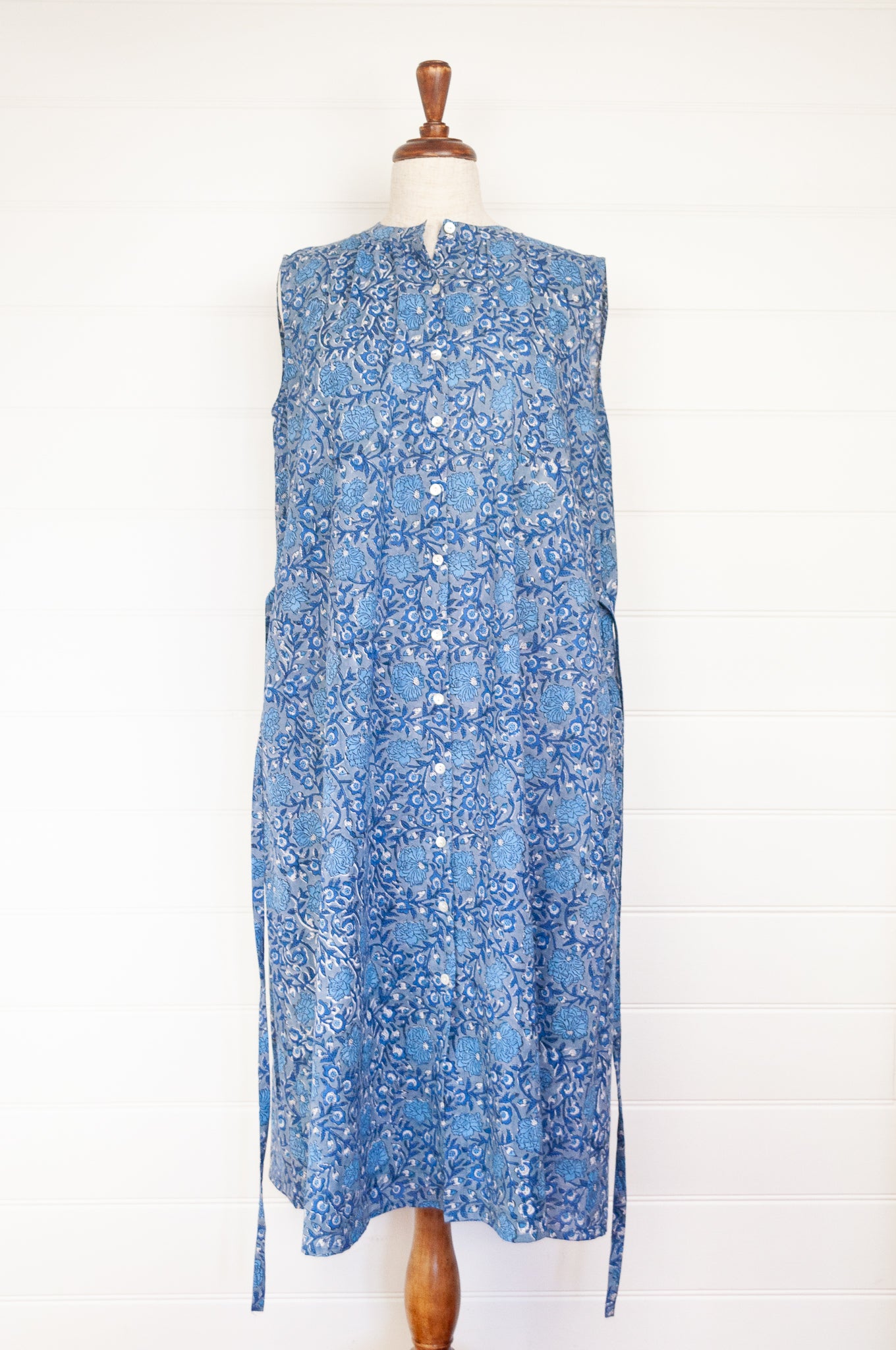 Juniper hearth Zoe dress button up sleeveless with waist ties, made from cotton blue grey blockprint floral.