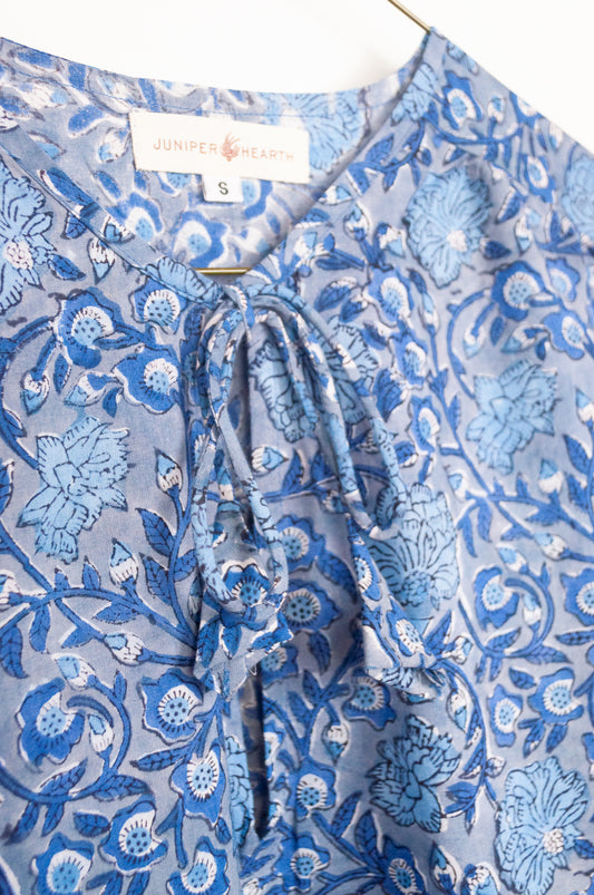 Juniper Hearth Stella dress in blue grey blockprint floral cotton, A-line sleeveless with front ties.