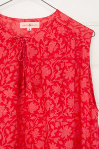 Juniper Hearth Stella dress in cherry pink red blockprint floral cotton, A-line sleeveless with front ties.