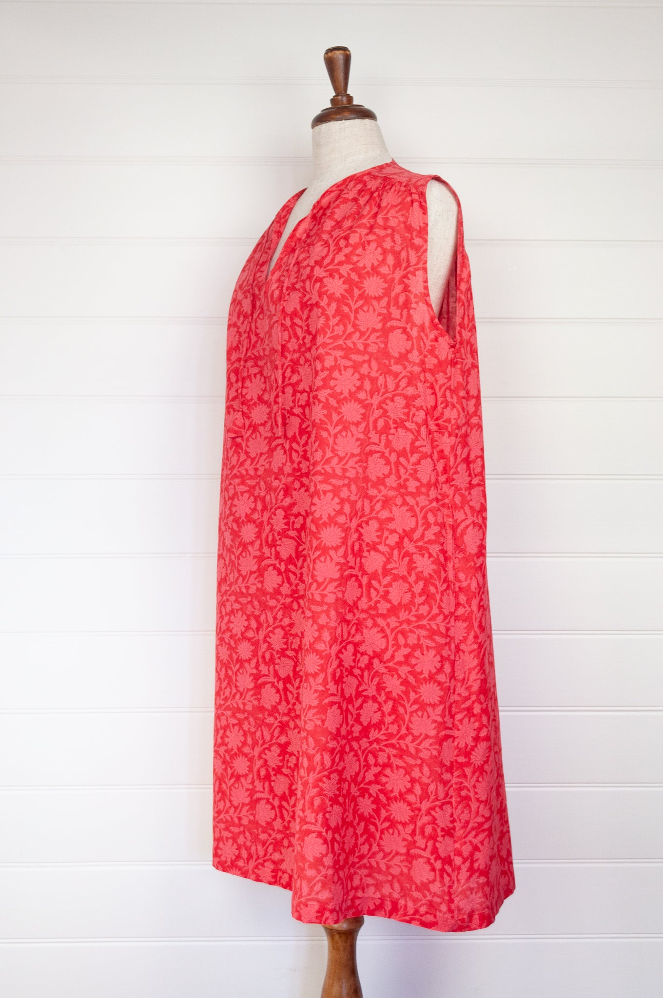 Juniper Hearth Stella dress in cherry pink red blockprint floral cotton, A-line sleeveless with front ties.