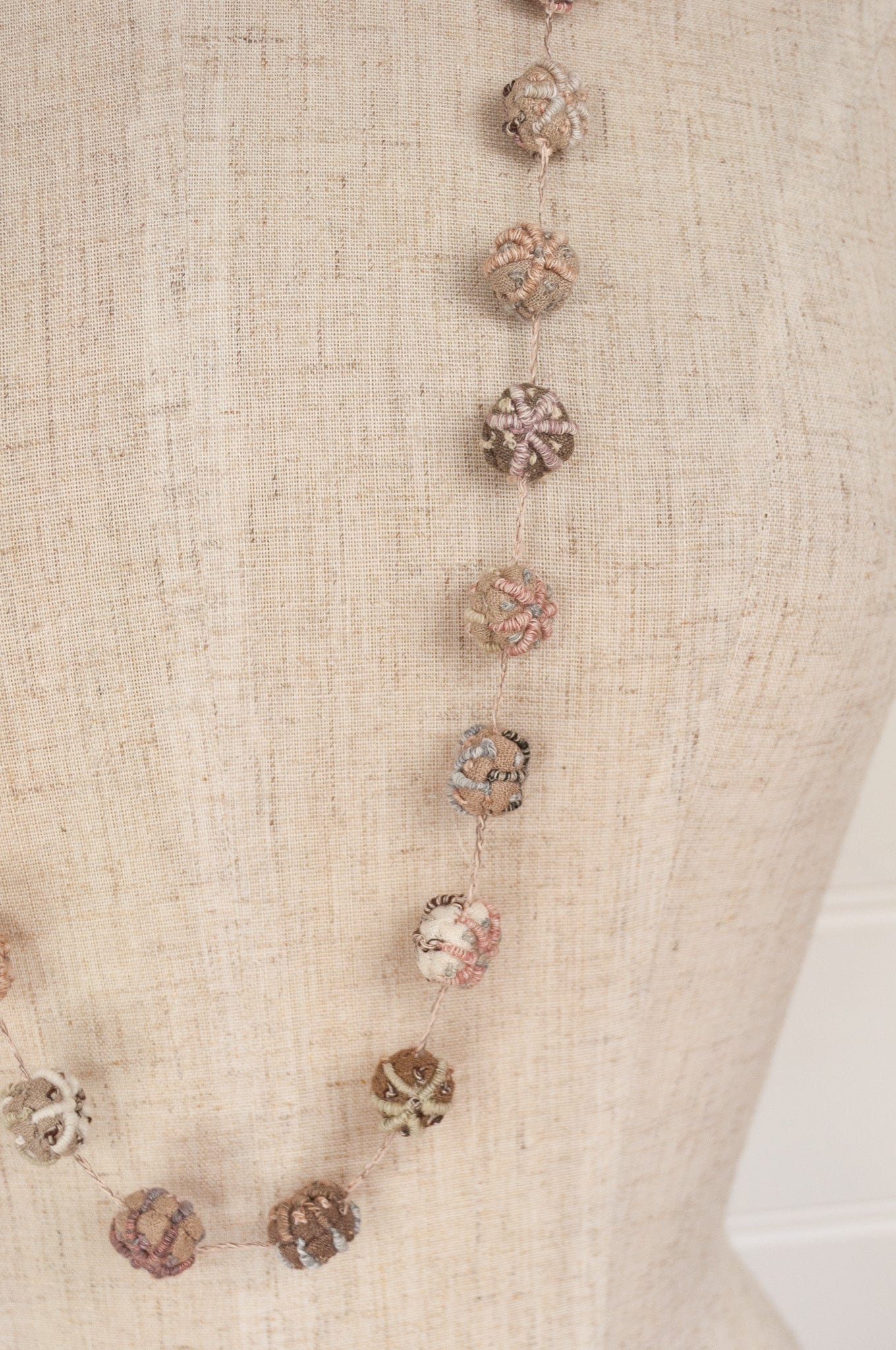 Sophie Digard hand made embroidered linen beads in neutral tones.