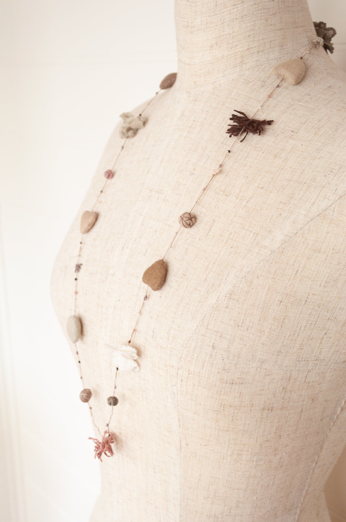 Sophie Digard hand made linen necklace, a string of hearts, flowers and beads in neutral tones.