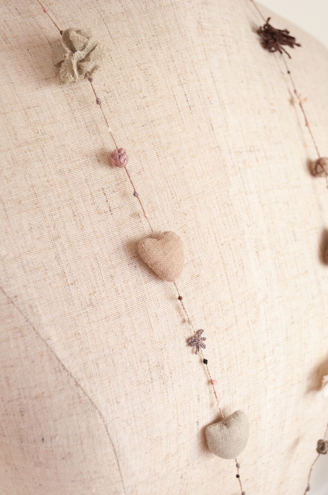 Sophie Digard hand made linen necklace, a string of hearts, flowers and beads in neutral tones.