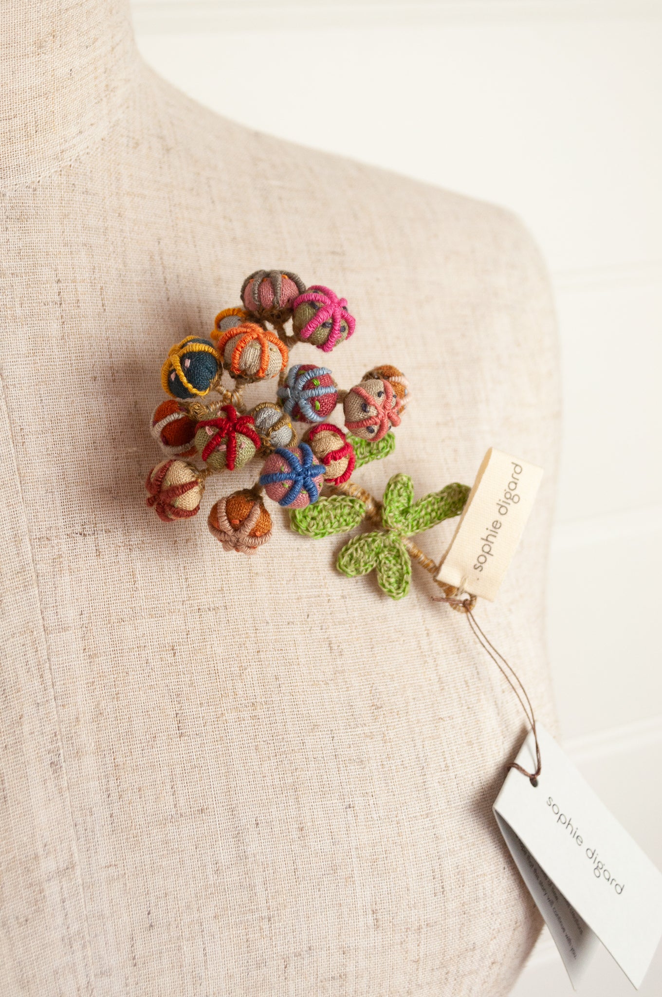 Sophie Digard handmade linen flower brooch in warm colours.