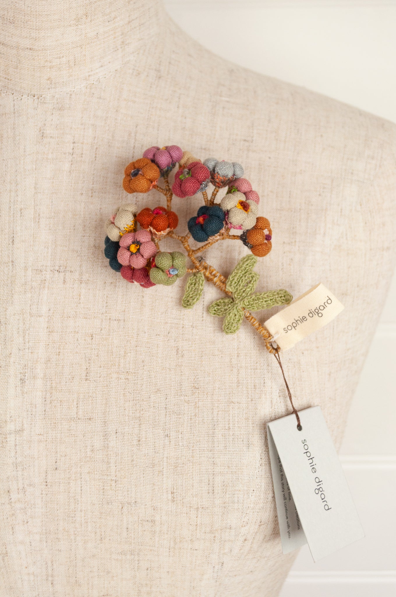 Sophie Digard handmade linen flower brooch in warm colours.