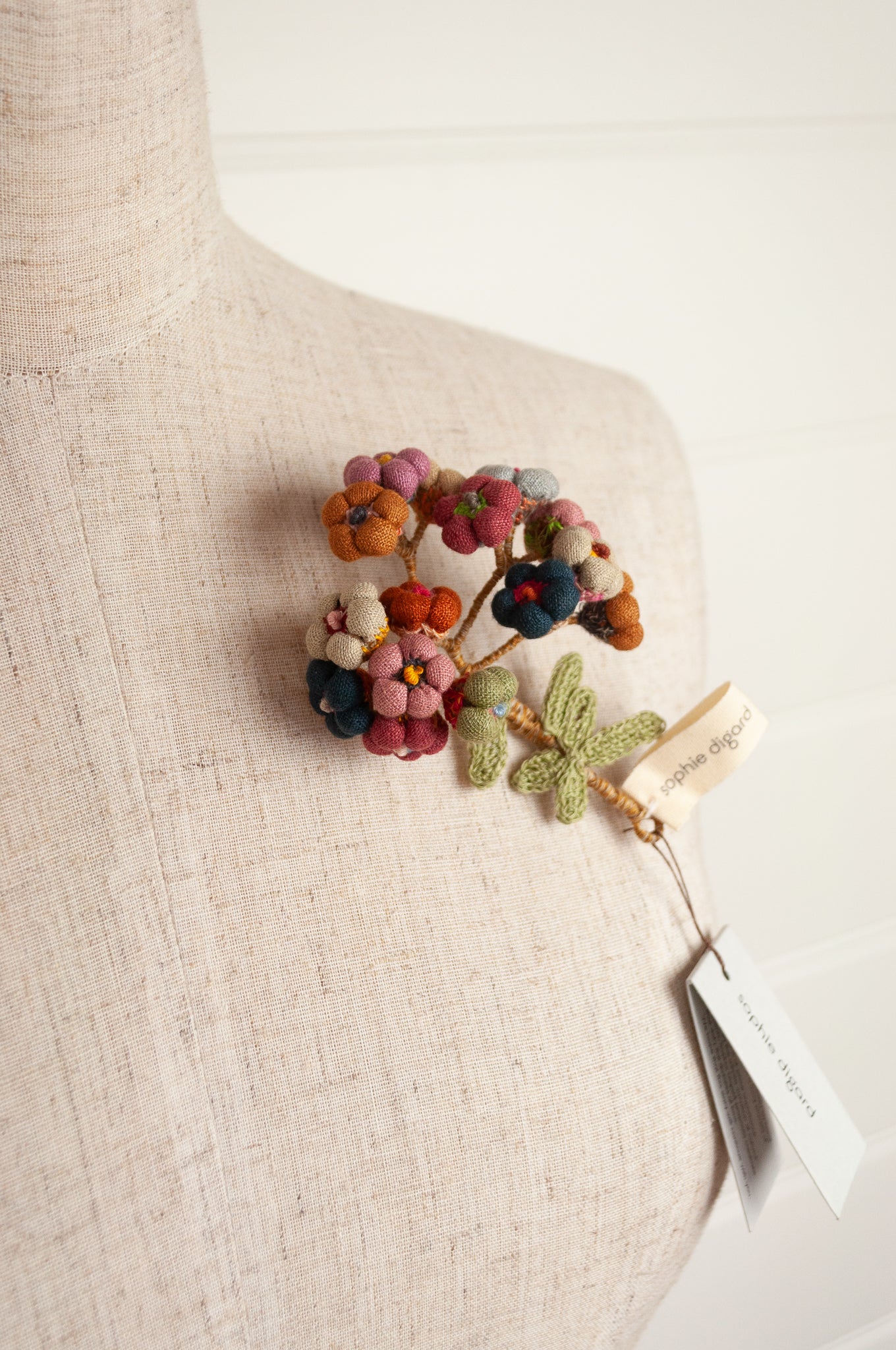 Sophie Digard handmade linen flower brooch in warm colours.
