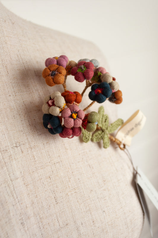 Sophie Digard handmade linen flower brooch in warm colours.
