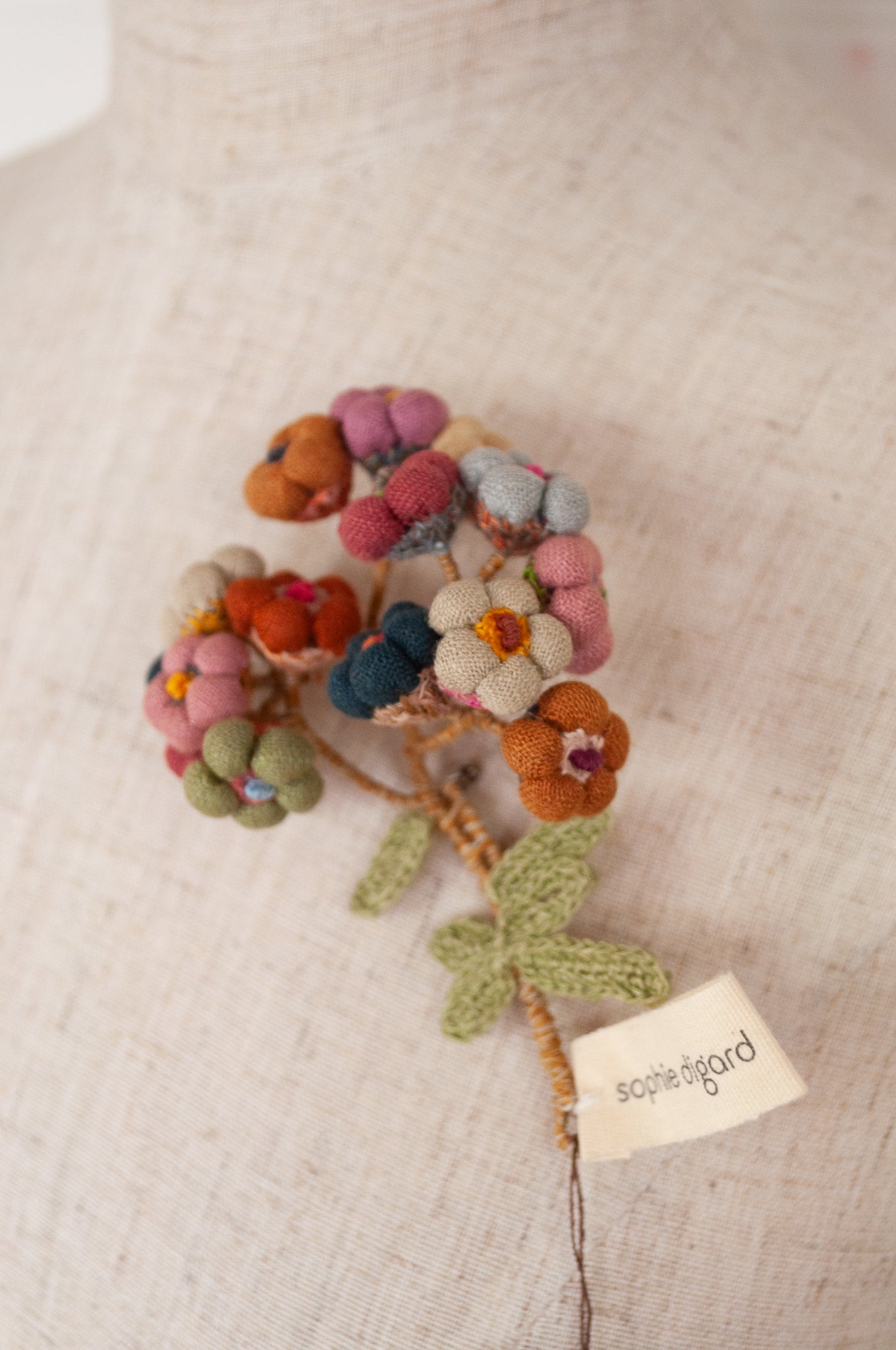 Sophie Digard handmade linen flower brooch in warm colours.