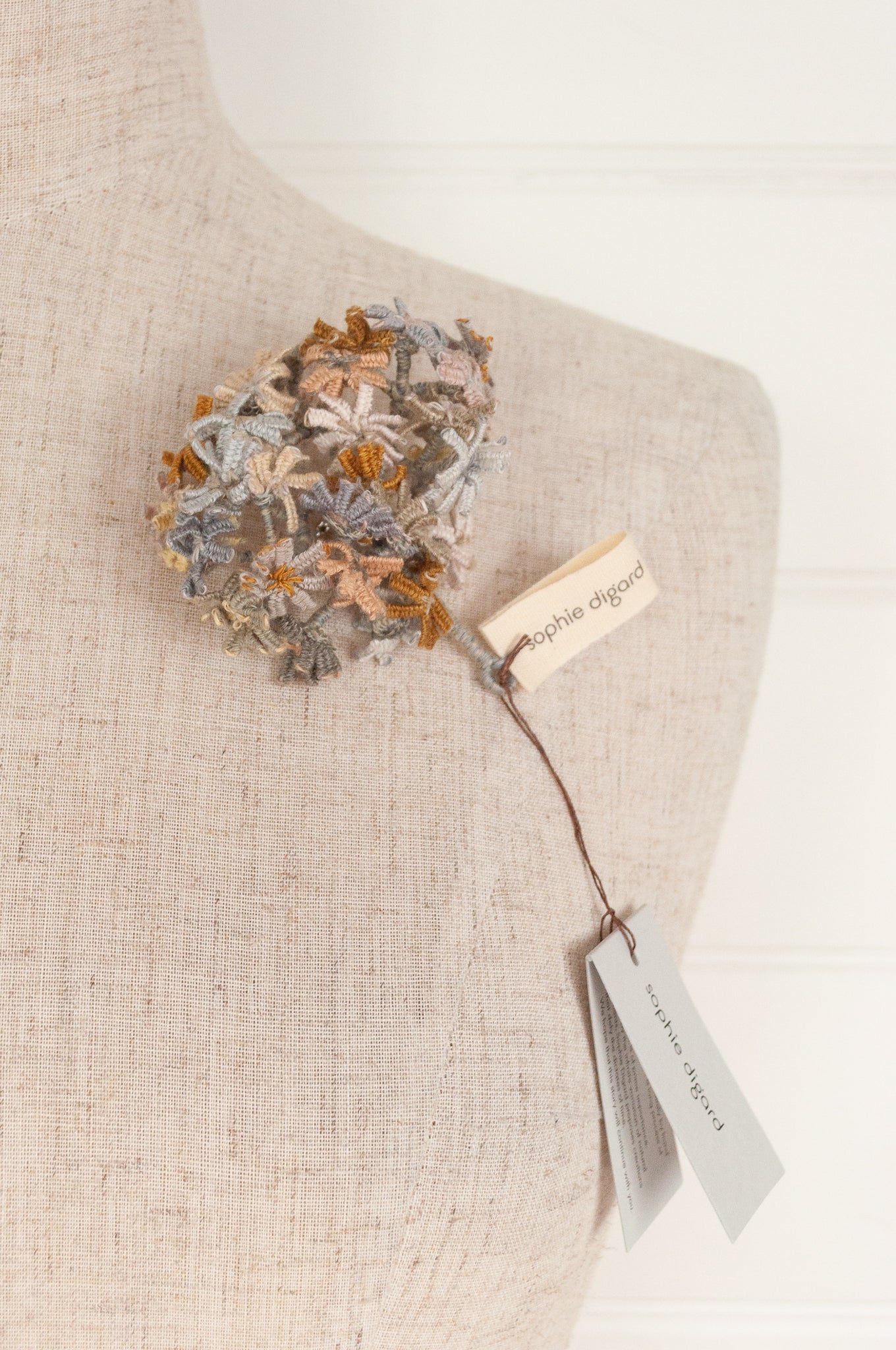 Sophie Digard floral brooch, hand embroidered and crocheted in line in soft neutral tones.