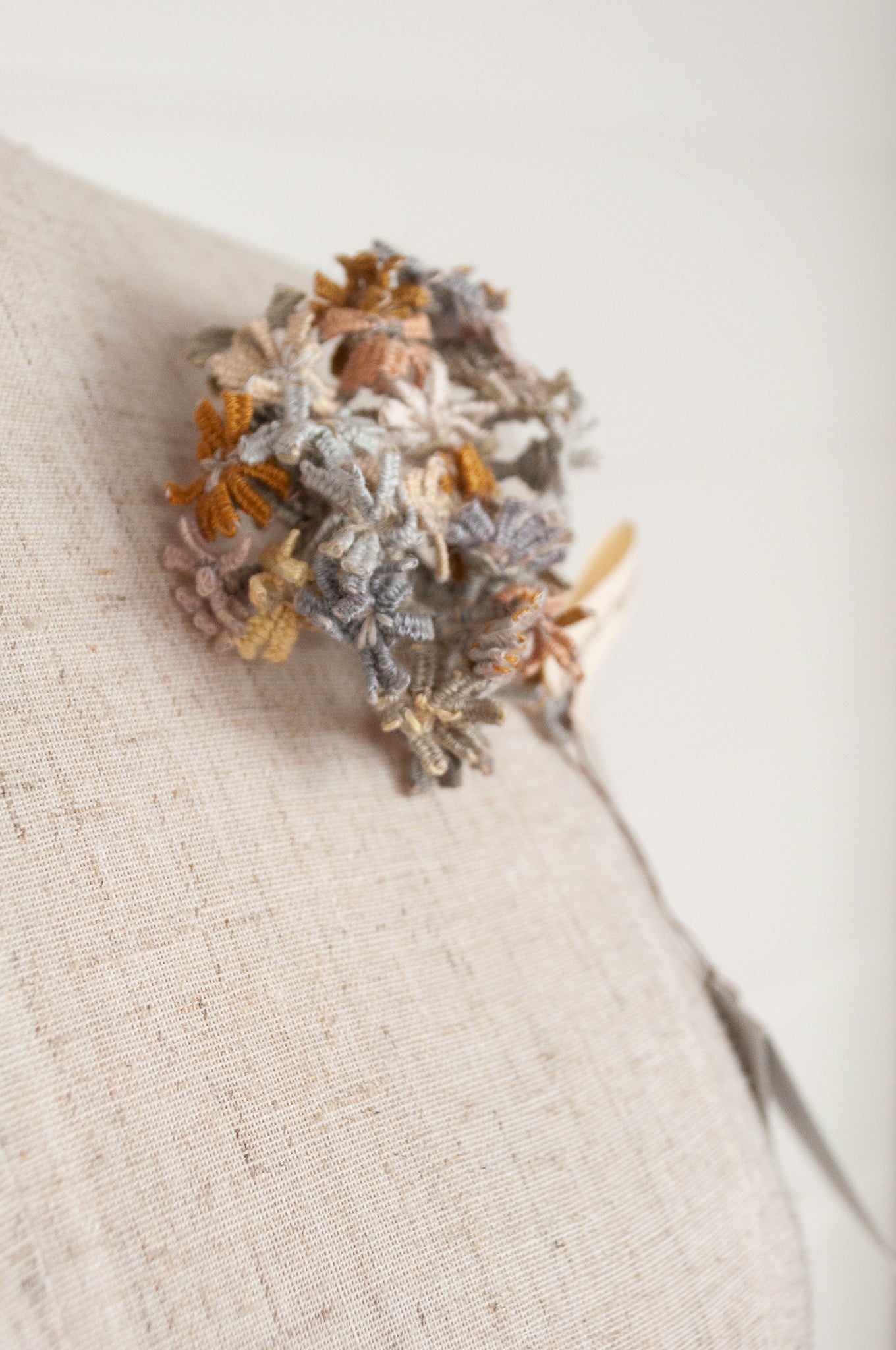 Sophie Digard floral brooch, hand embroidered and crocheted in line in soft neutral tones.