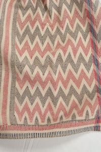 Traditional lohori wave kantha quilt in red and black on white background.