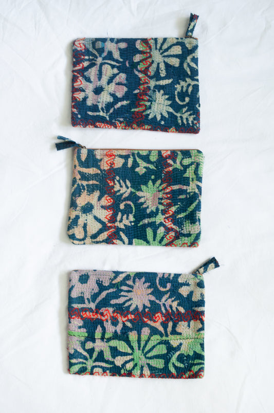 VIntage kantha pouch in overdyed indigo floral design with red stitching.