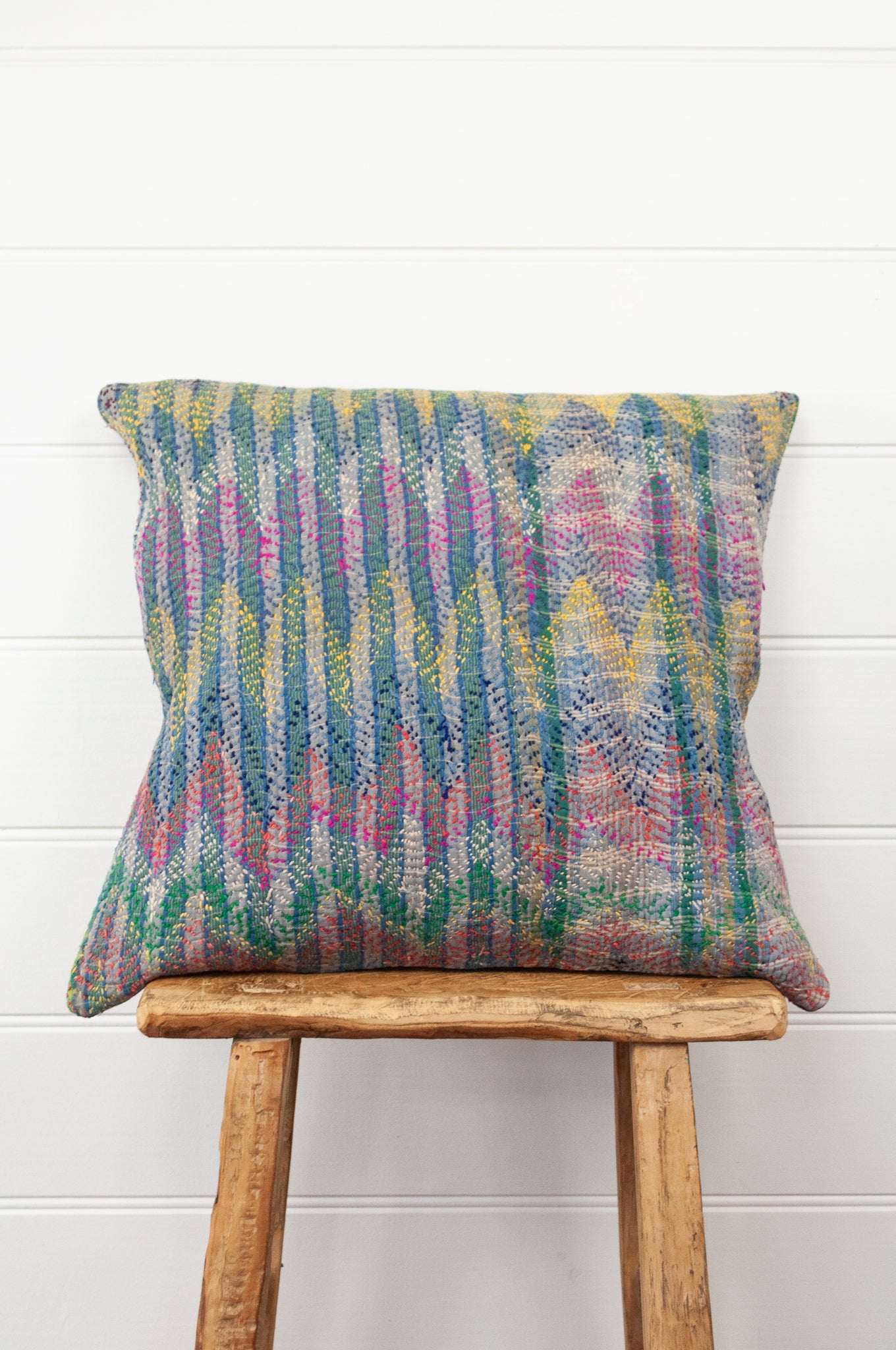 Lohori kantha stitch quilt cushion cover in multi-colour stitching on stripe background.
