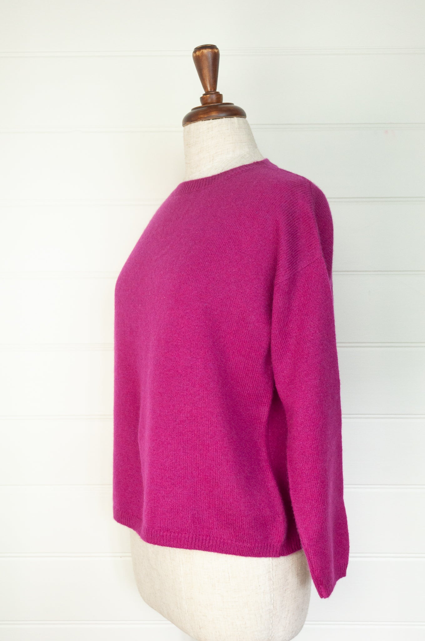 One size crew neck cashmere sweater ethically made in Nepal in vibrant magenta pink.