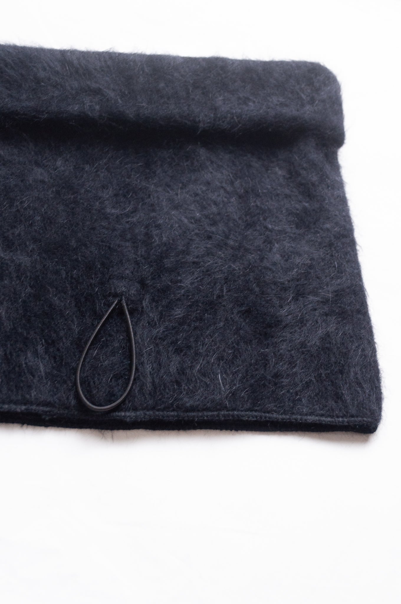 PCNQ black wool woven beanie with gather at top that releases to create a snood, made in Japan.