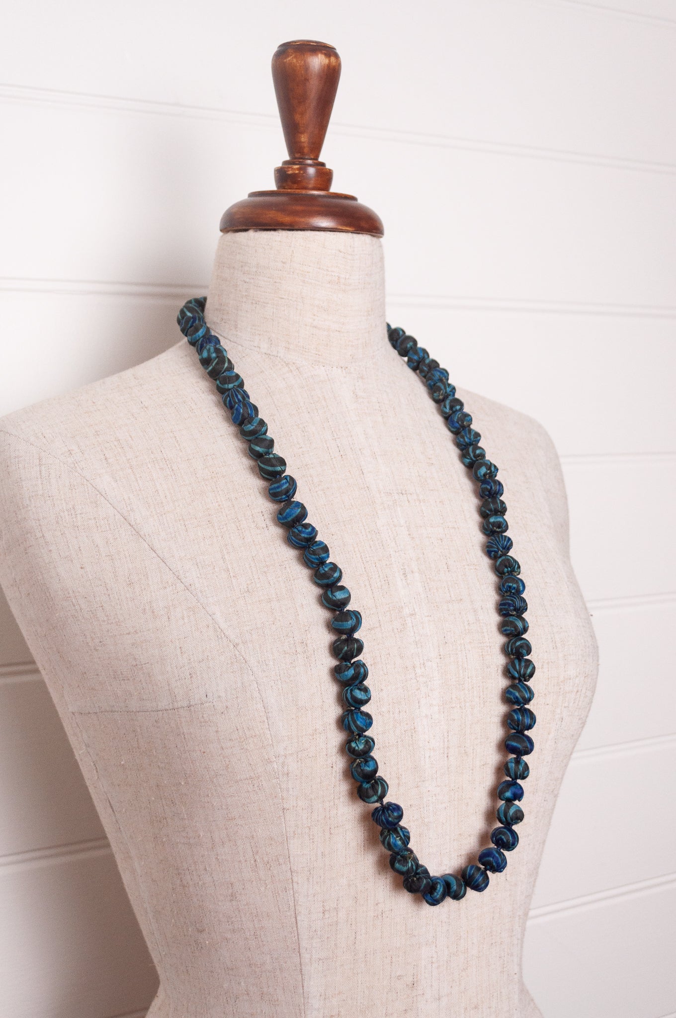 Neeru Kumar handmade fabric beads from silk shibori remnants in sapphire blue and green.