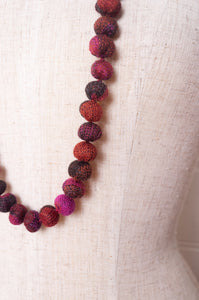Neeru Kumar wool fabric bead necklace using remnants in magenta pink fabric.