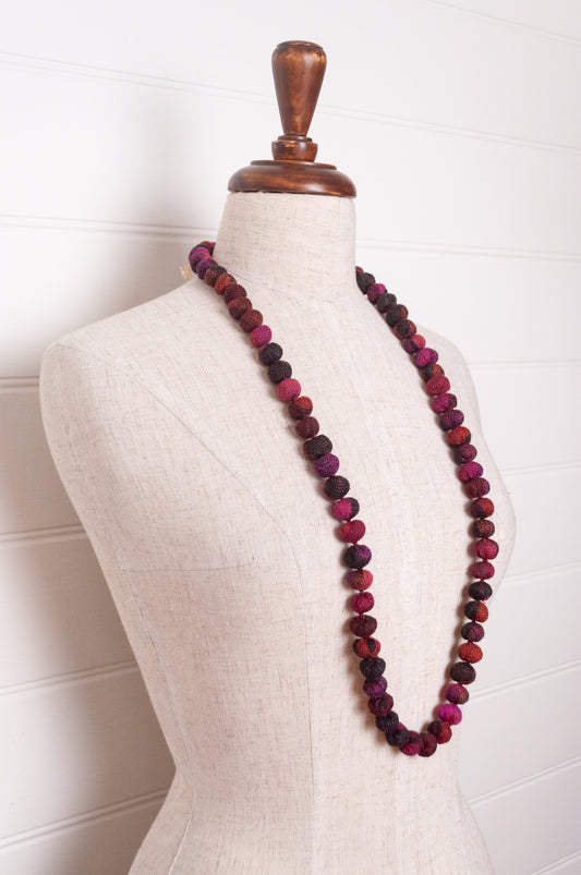 Neeru Kumar wool fabric bead necklace using remnants in magenta pink fabric.