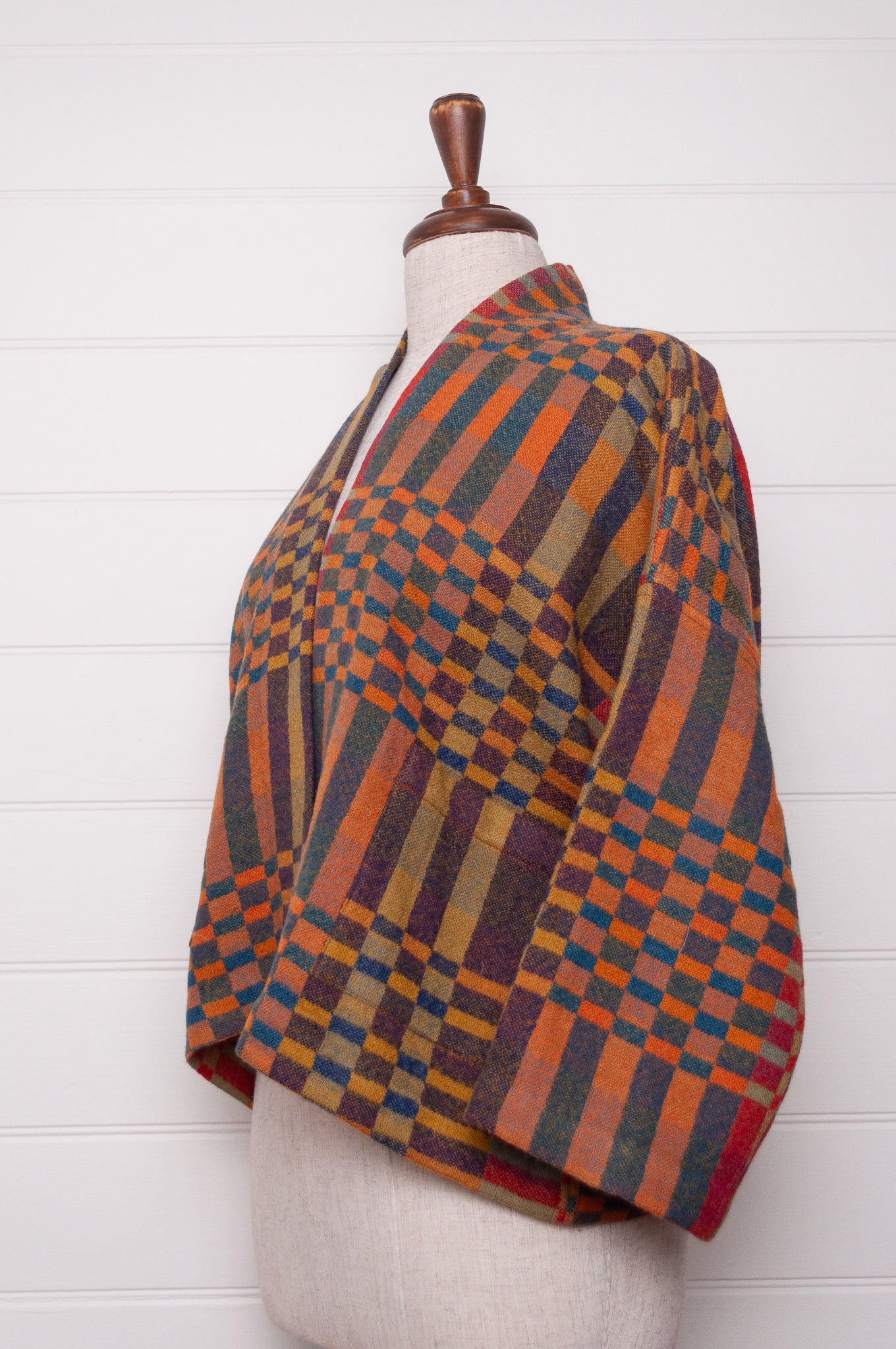 Neeru Kumar handwoven wool check kimono cropped jacket in olive, red, orange, mustard and charcoal.