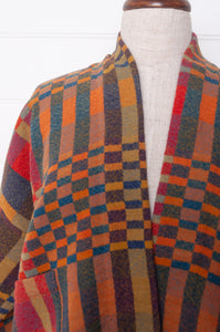 Neeru Kumar handwoven wool check kimono cropped jacket in olive, red, orange, mustard and charcoal.