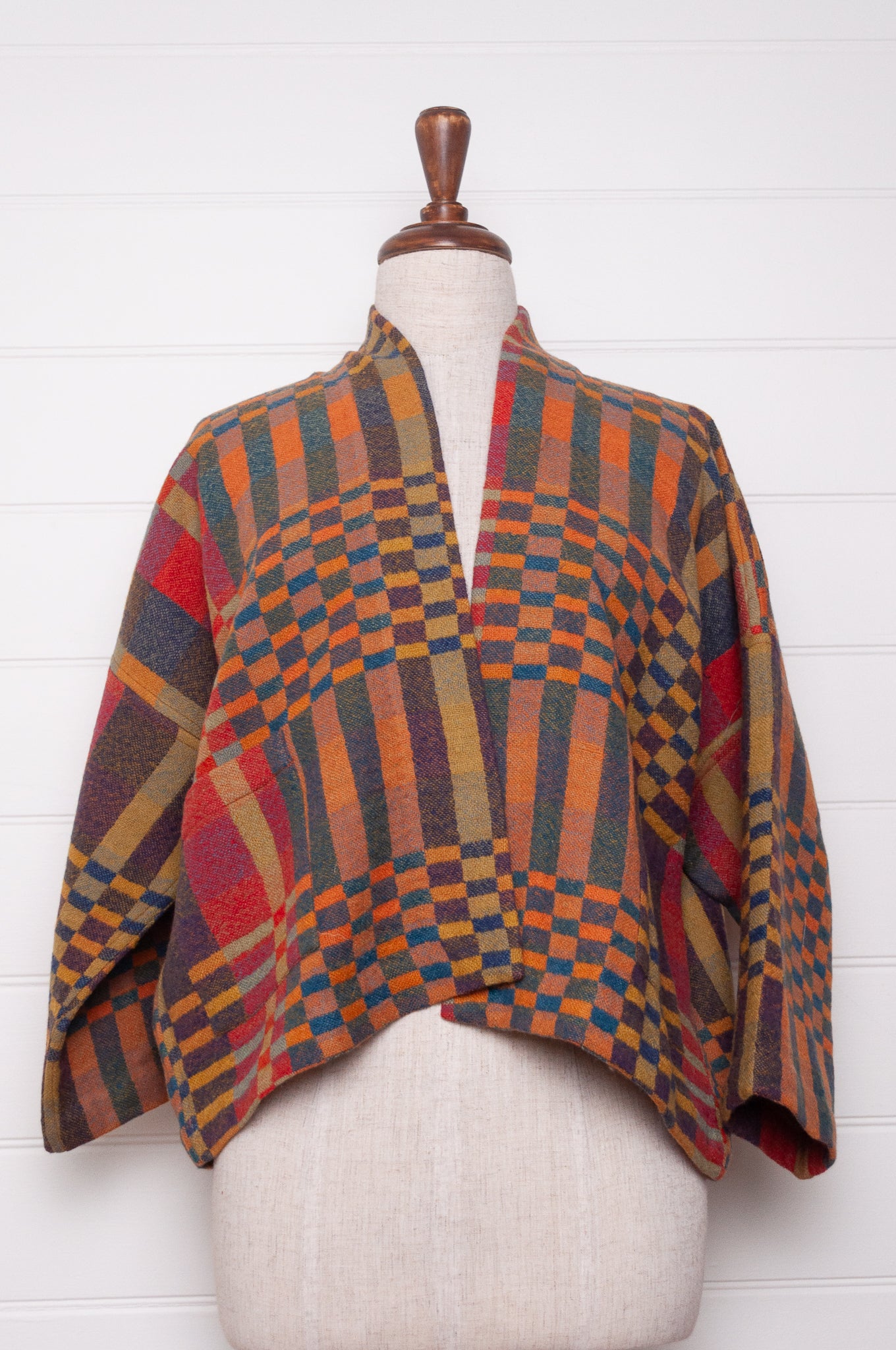 Neeru Kumar handwoven wool check kimono cropped jacket in olive, red, orange, mustard and charcoal.