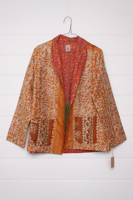 DVE Collection one of a kind reversible silk kantha Neeli jacket has an ecru floral print on saffron on one side, and also on the reverse on deep orange..