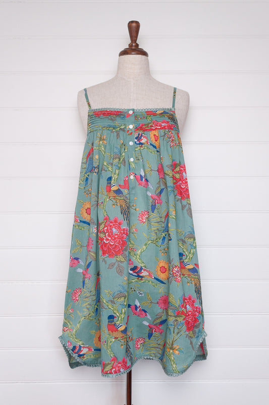 Juniper Hearth cotton voile nightdress with brightly coloured birds and flowers on an aqua background.