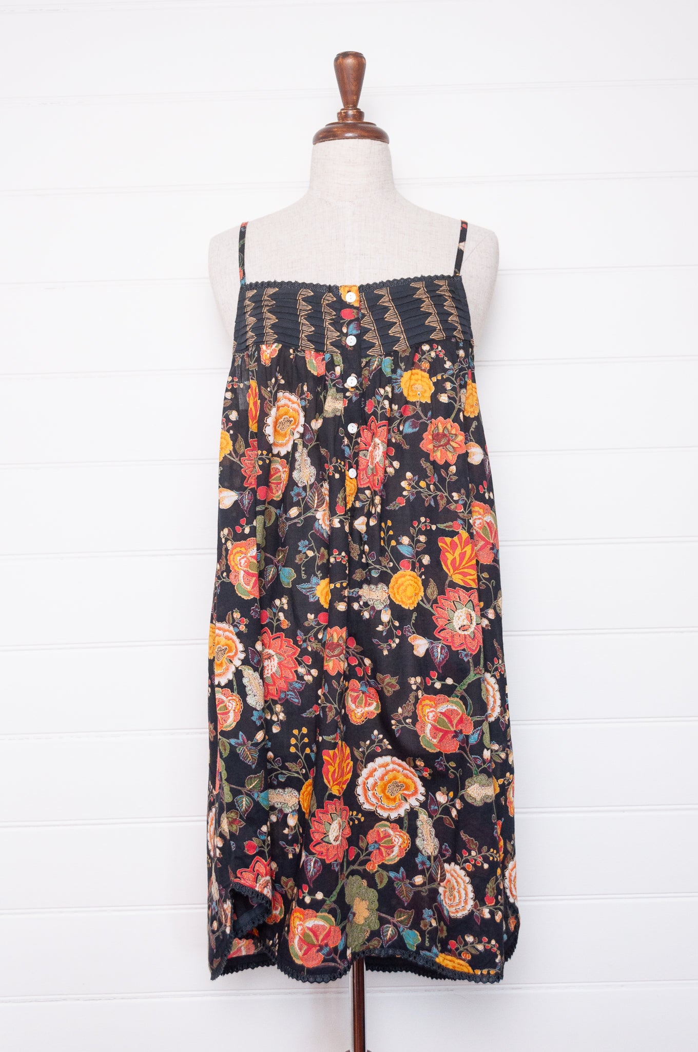 Juniper Hearth cotton voile nightdress in a vibrant all over tropical floral in coral, ecru and olive green on a black background