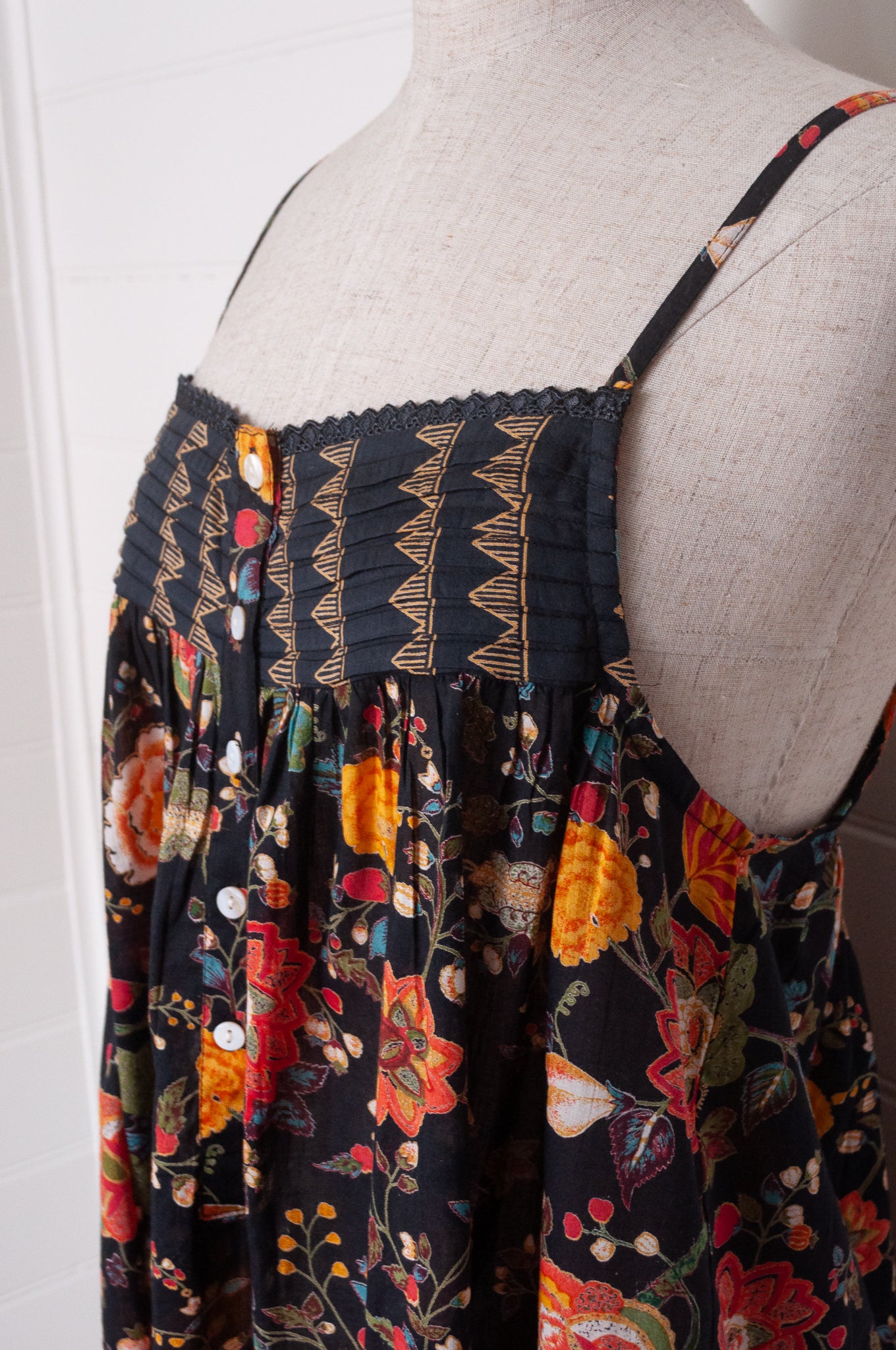 Juniper Hearth cotton voile nightdress in a vibrant all over tropical floral in coral, ecru and olive green on a black background