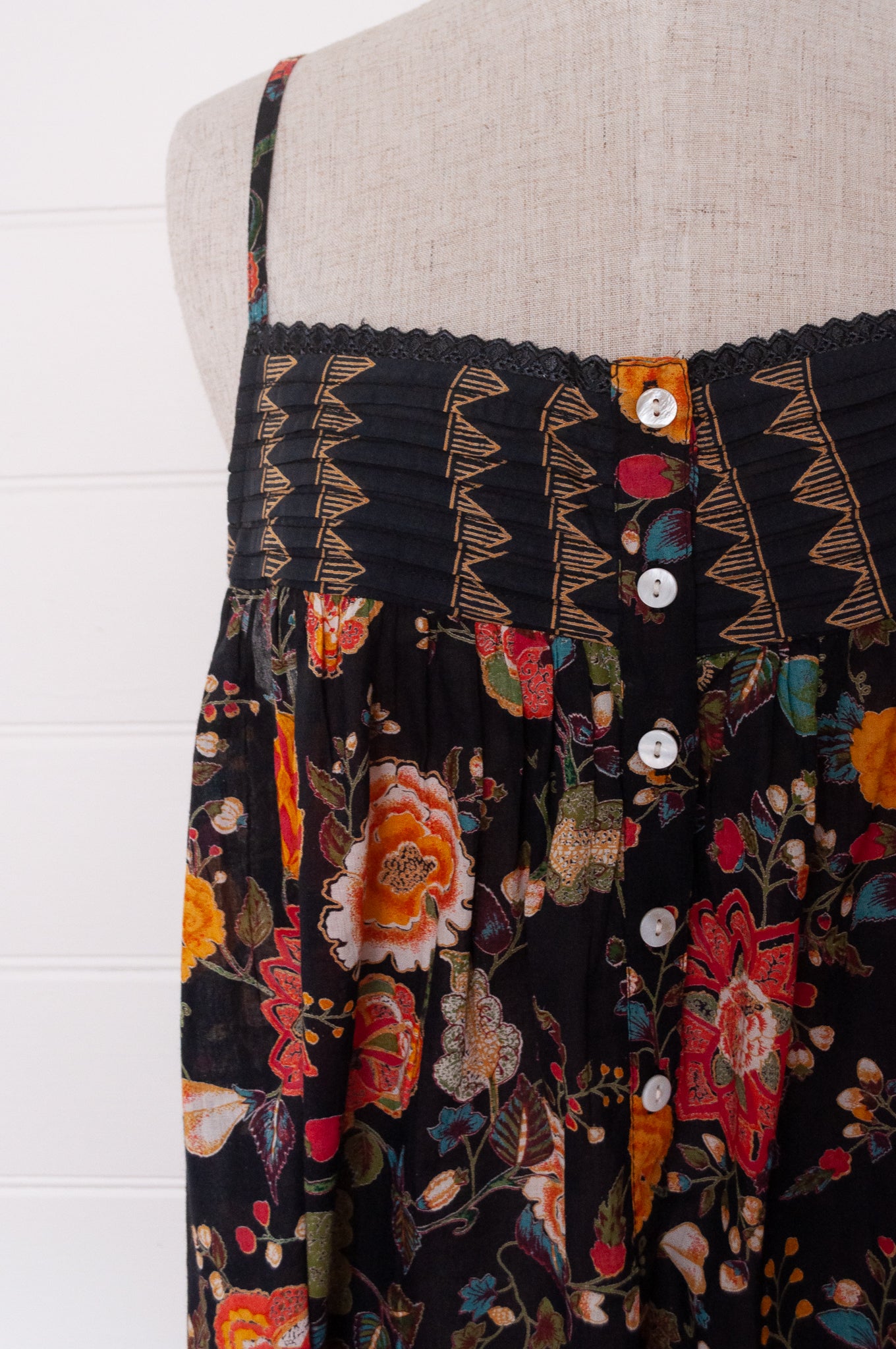 Juniper Hearth cotton voile nightdress in a vibrant all over tropical floral in coral, ecru and olive green on a black background