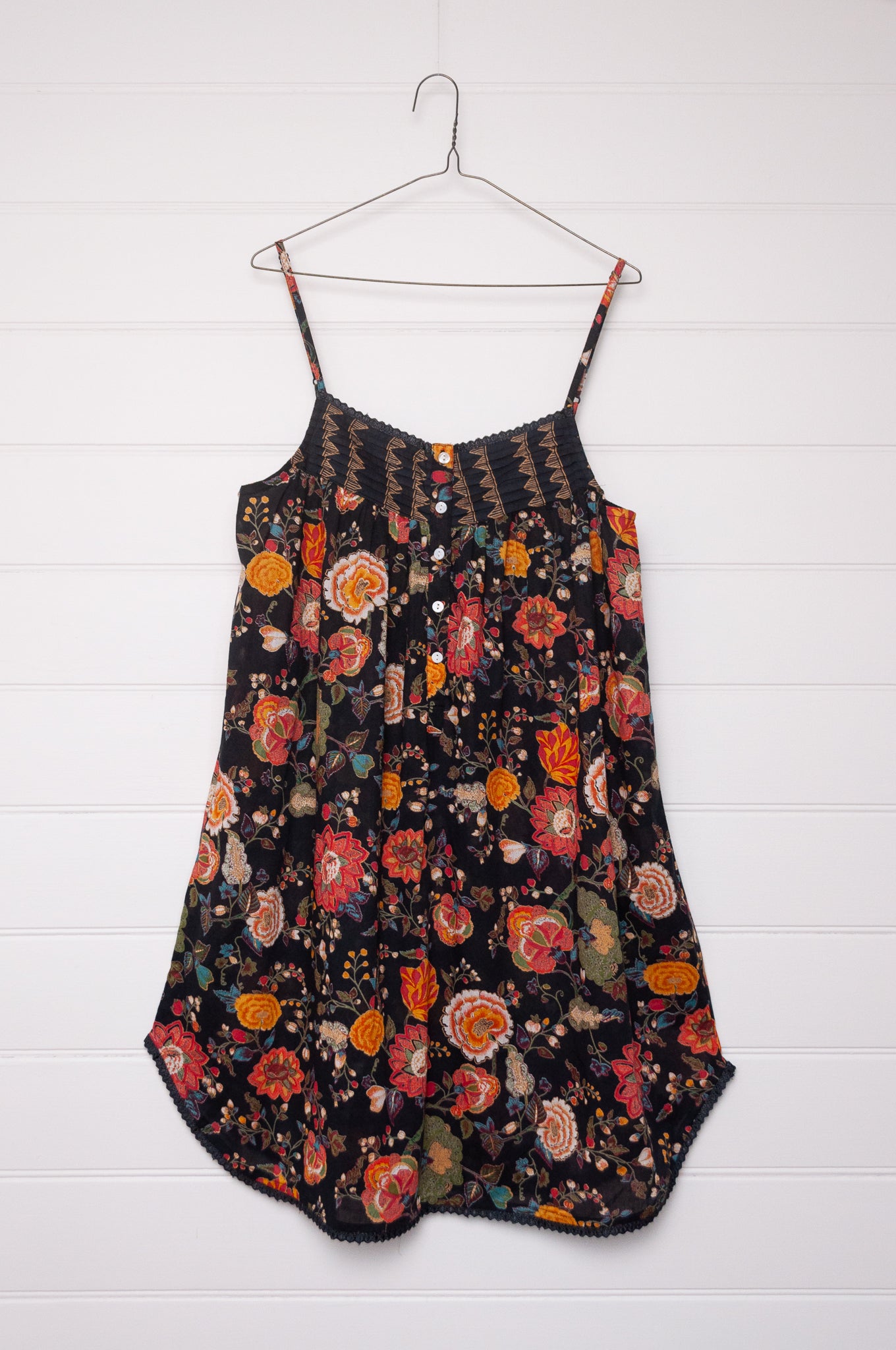 Juniper Hearth cotton voile nightdress in a vibrant all over tropical floral in coral, ecru and olive green on a black background