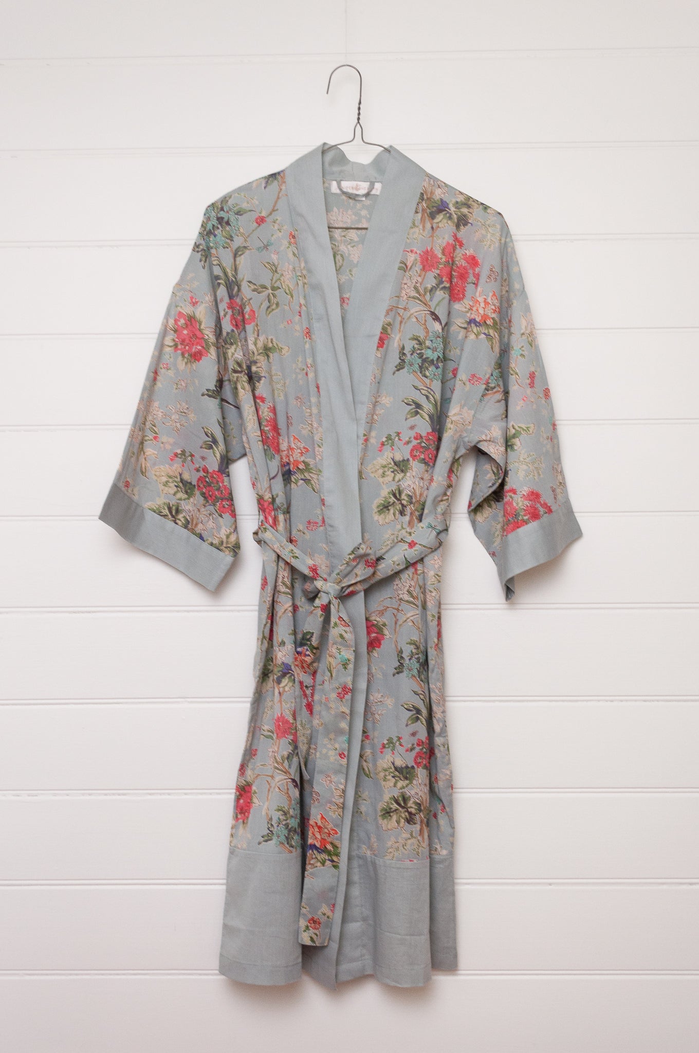 Juniper Hearth cotton voile kimono in country garden print, pink and vanilla flowers on duck egg blue background.