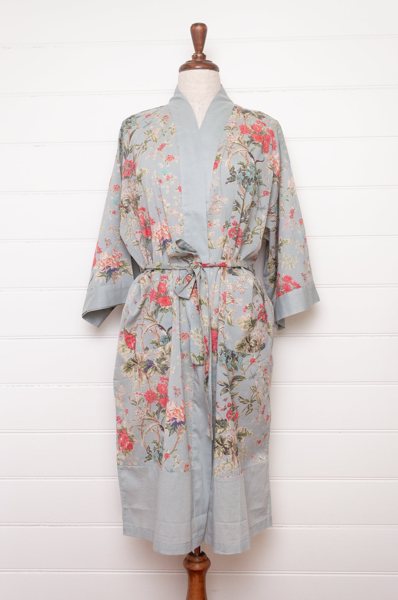 Juniper Hearth cotton voile kimono in country garden print, pink and vanilla flowers on duck egg blue background.