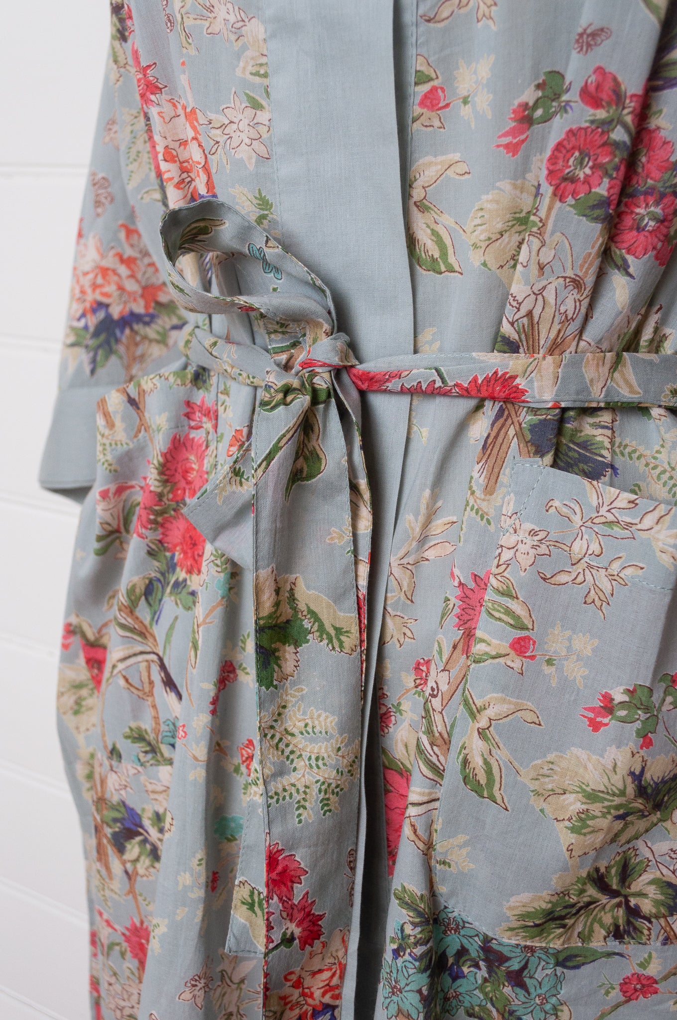 Juniper Hearth cotton voile kimono in country garden print, pink and vanilla flowers on duck egg blue background.